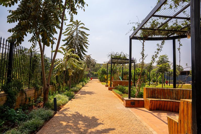 landscaped garden path lined with trees and shrubs, Garden City