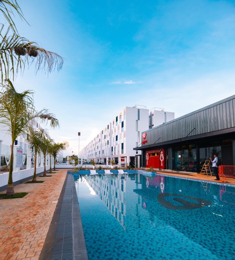 Long lap pool running alongside an apartment block, Tatu City