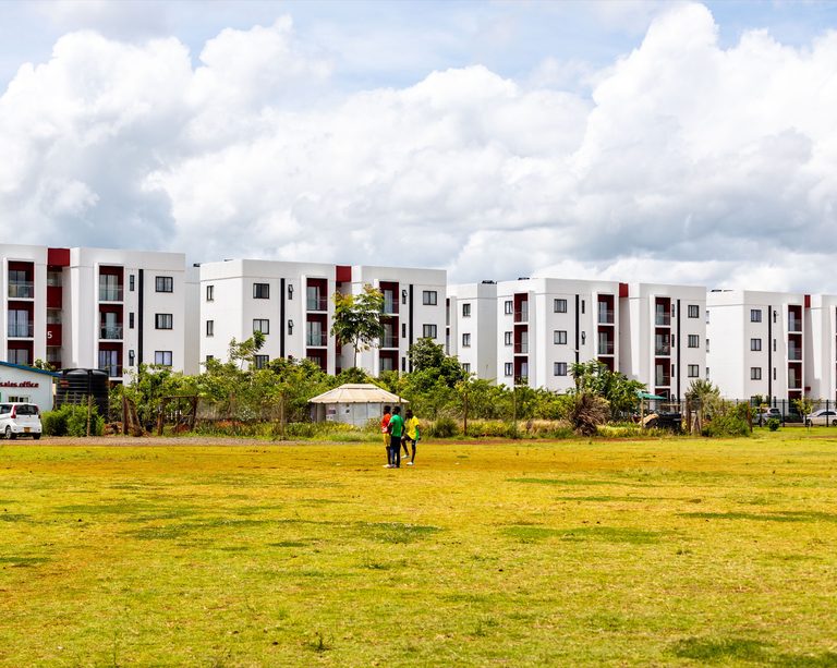 Wide open grass lawn with apartment blocks in the distance, Tatu City