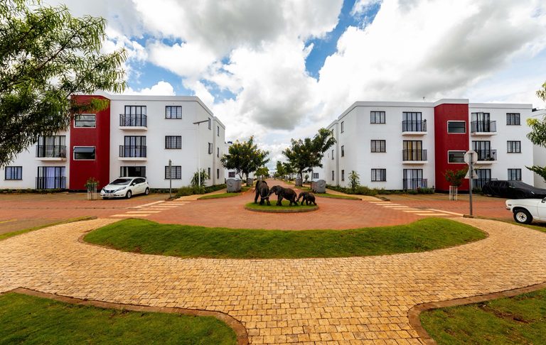 Wide paved estate courtyard with a circular central lawn, Tatu City