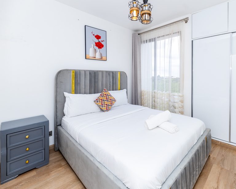 Grey tufted bed with patterned cushion, fourth view, The Deco, Tatu City