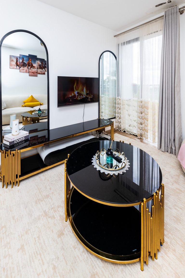 Tall mirrors, gold coffee tables and TV in the living room, The Deco, Tatu City