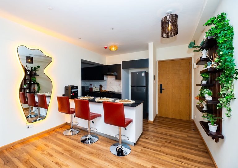 kitchen counter with bar stools and the hallway to the front door, The Emerald, Garden City