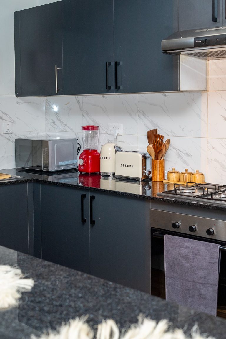 kitchen cabinets, cooker and oven along the counter, The Emerald, Garden City