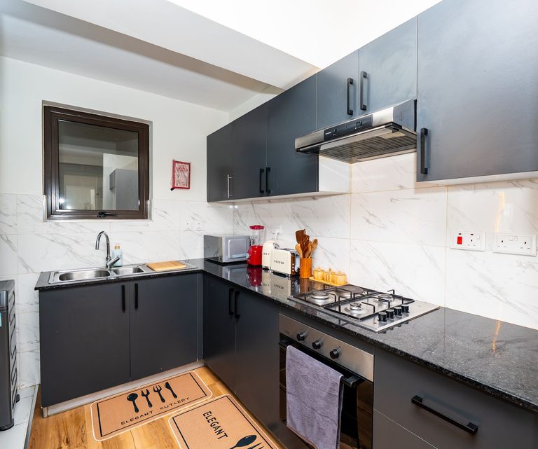 kitchen with a gas cooker, dark cabinets and marble tile, The Emerald, Garden City