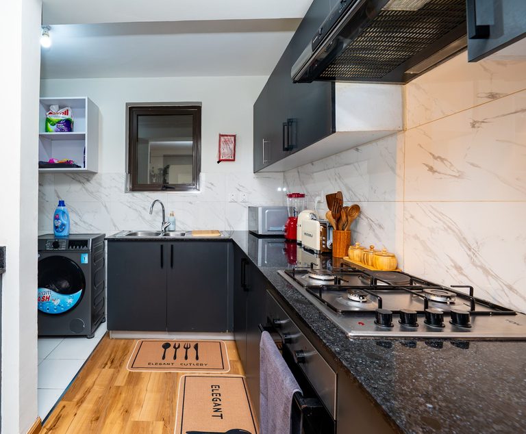 kitchen cooker area with a washing machine to the side, The Emerald, Garden City