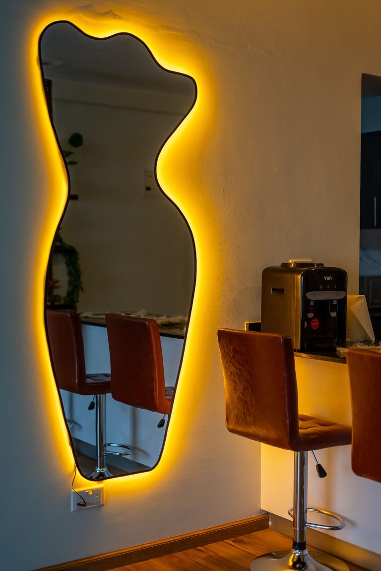 kitchen counter close up with the backlit mirror and bar stools, The Emerald, Garden City