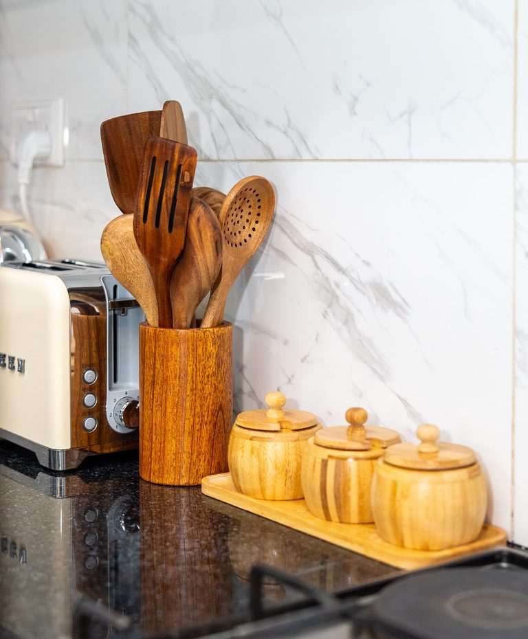 kitchen counter with wooden utensils and storage jars, The Emerald, Garden City