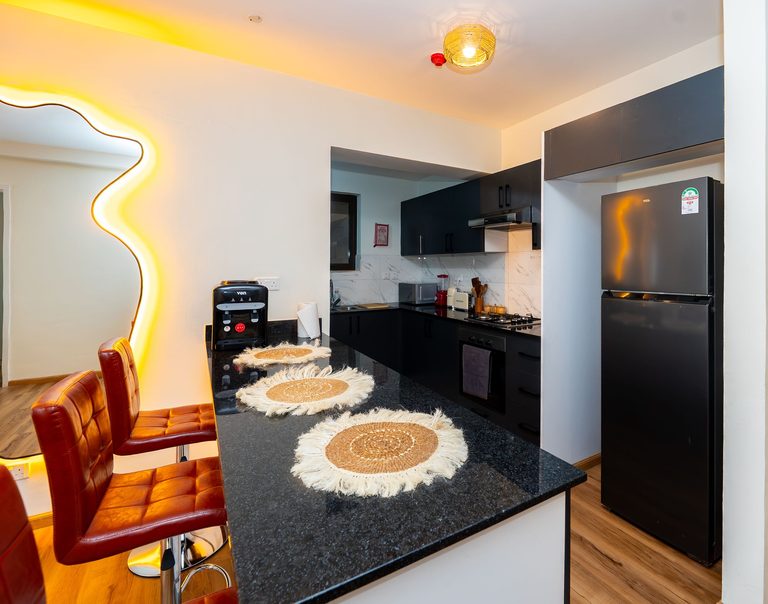 kitchen counter with woven placemats and a coffee maker, The Emerald, Garden City