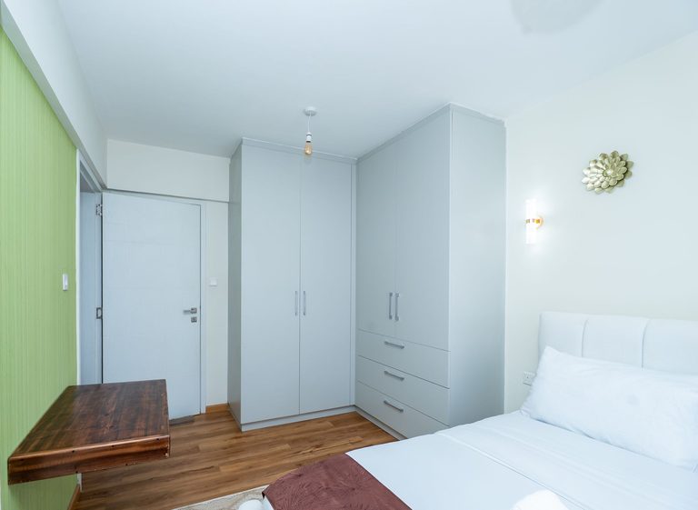 bedroom wardrobe and small bench seen from the doorway, The Emerald, Garden City