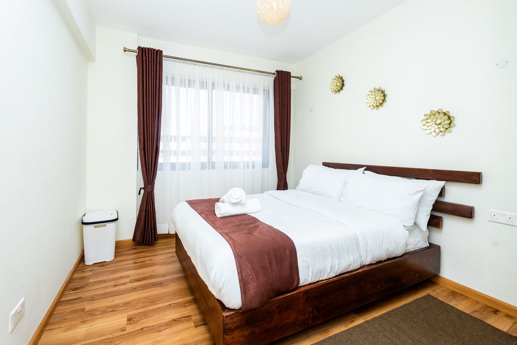 second bedroom with a bed facing a curtained window, The Emerald, Garden City