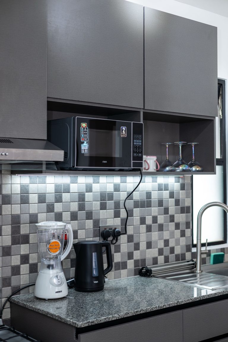 Kitchen counter with blender, kettle and grey upper cabinets, The Gallery, Tatu City
