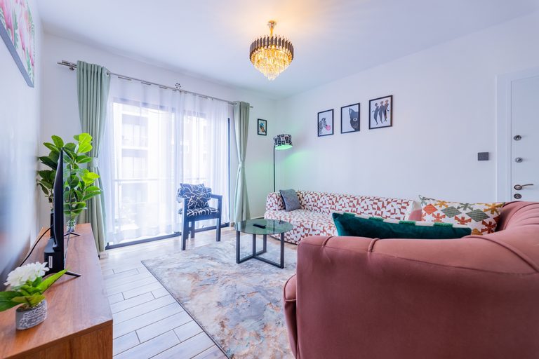 Living room with a crystal chandelier, patterned sofa and TV console, The Gallery, Tatu City