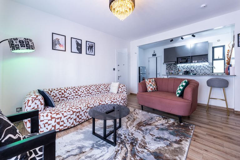 Full living room view with sofa, loveseat and the open kitchen, The Gallery, Tatu City