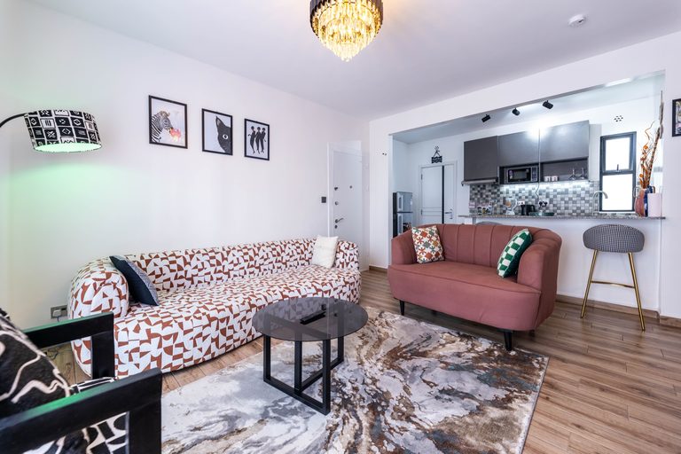 Living room wide view with sofa, loveseat and pass-through to the kitchen, The Gallery, Tatu City