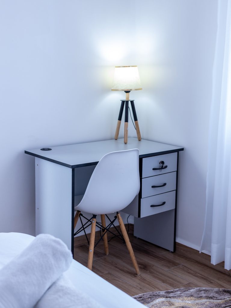 Study desk with a white chair and lamp in the second bedroom, The Gallery, Tatu City