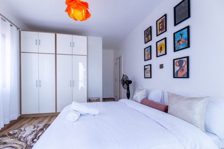Second bedroom wide view with wardrobe, gallery wall and bed, The Gallery, Tatu City