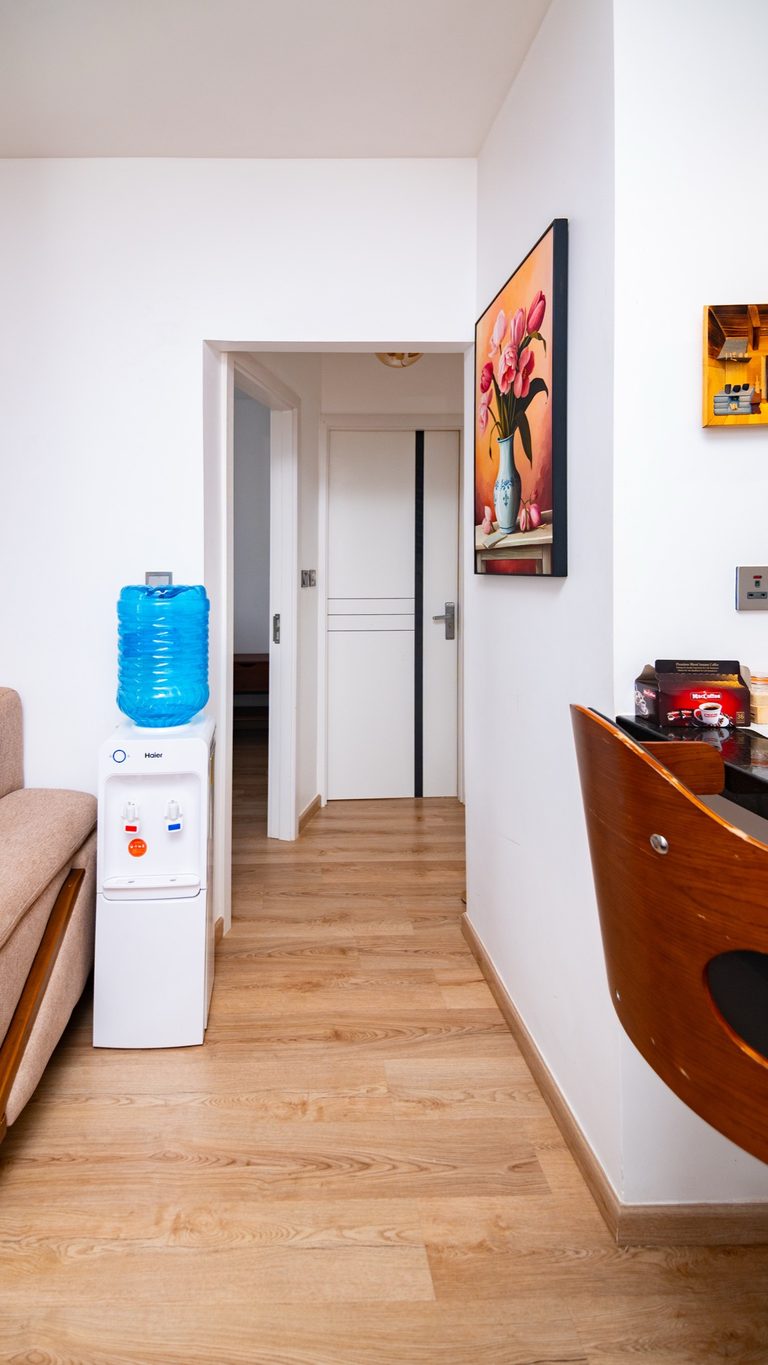 Hallway corridor with a water dispenser and a wood console table, The Hearth, Tatu City