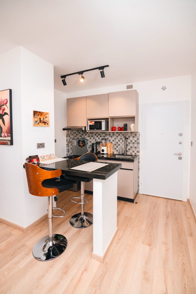 Kitchen breakfast bar with tiled backsplash and a doorway to the entrance, The Hearth, Tatu City