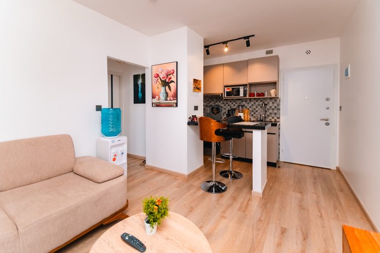 Sofa with the breakfast counter visible in the open plan layout, The Hearth, Tatu City
