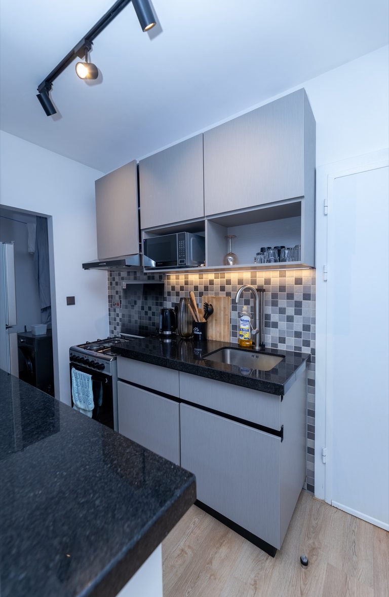 Full kitchen layout with a gas stove, extractor hood, sink and overhead cabinets, The Tide, Tatu City
