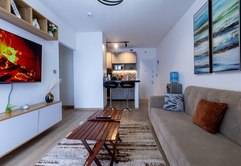 Living room TV wall with a hallway leading to the kitchen breakfast bar, The Tide, Tatu City