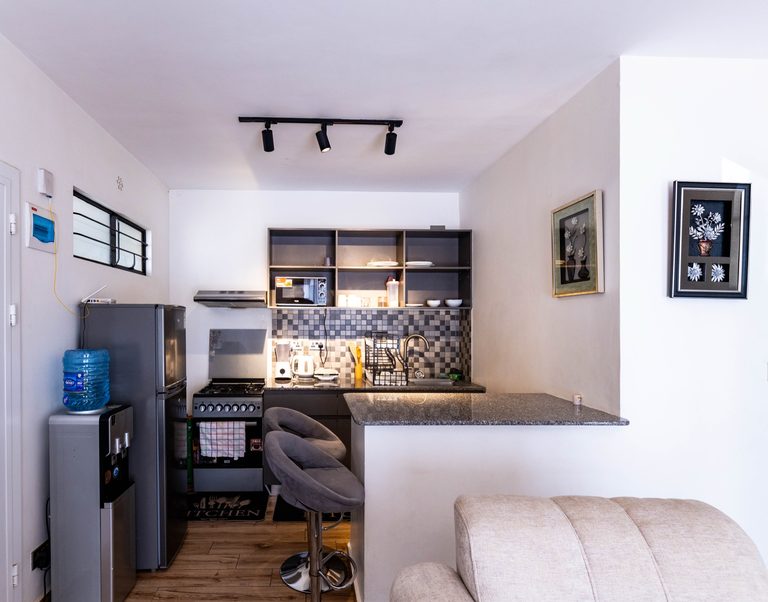 Kitchen wide view with breakfast bar and water dispenser, The Velvet, Tatu City
