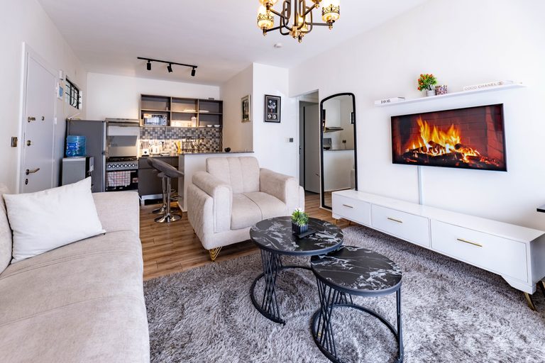 Living room wide view with TV fireplace wallpaper and the open kitchen, The Velvet, Tatu City