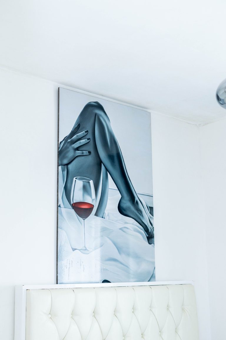 Close-up of the monochrome wine painting above the headboard, The Velvet, Tatu City